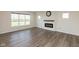 Inviting living room with hardwood floors, fireplace, and lots of natural light from the large windows at 4016 Railhead Ave, Westfield, IN 46074