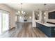 Open-concept living space with hardwood floors, fireplace, and access to the kitchen, perfect for entertaining at 4016 Railhead Ave, Westfield, IN 46074