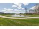 A picturesque pond with a fountain, surrounded by lush green lawns and a walking path, enhances this community at 4016 Railhead Ave, Westfield, IN 46074