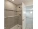 Walk-in shower with tiled walls and a glass door, seamlessly connecting to an adjacent room at 4016 Railhead Ave, Westfield, IN 46074