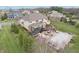 Aerial view of a backyard with a covered patio, outdoor kitchen, firepit, and covered pool at 4429 Serengeti Cir, Carmel, IN 46074