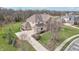 An aerial shot shows the home's driveway, garage, and landscaping with mature trees on the property at 4429 Serengeti Cir, Carmel, IN 46074