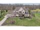 Aerial view of a lovely brick home with manicured front lawn and professional landscaping at 4429 Serengeti Cir, Carmel, IN 46074