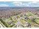 Neighborhood aerial view showcasing houses, ponds, mature trees, and community layout at 4429 Serengeti Cir, Carmel, IN 46074