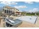 Large backyard boasts a pool, patio, lounge chairs, and a covered dining area for seamless outdoor entertaining and relaxation at 4429 Serengeti Cir, Carmel, IN 46074