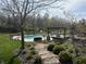 Lush backyard featuring a sparkling pool, pergola-covered seating area, and manicured landscaping, creating an outdoor oasis at 4429 Serengeti Cir, Carmel, IN 46074