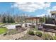 Stunning backyard featuring a pool, spa, pergola-covered lounge area, and lush landscaping for ultimate outdoor enjoyment at 4429 Serengeti Cir, Carmel, IN 46074