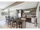 Entertaining bar area with countertop seating, a TV, stone backsplash, and cabinetry at 4429 Serengeti Cir, Carmel, IN 46074