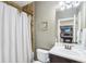 Well-appointed bathroom with a shower, dark wood vanity, and a view into an adjacent entertainment space at 4429 Serengeti Cir, Carmel, IN 46074