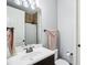 A clean bathroom with a white sink, dark cabinets, and a towel rack at 4429 Serengeti Cir, Carmel, IN 46074