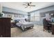 Serene bedroom with gray bedding, dark wood furniture, and a desk area for work or study at 4429 Serengeti Cir, Carmel, IN 46074
