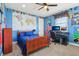 Bright bedroom with a wooden bed frame, world map, and desk setup, perfect for study and rest at 4429 Serengeti Cir, Carmel, IN 46074