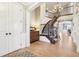 Stately foyer with a grand staircase, chandelier, and hardwood floors leading to other rooms at 4429 Serengeti Cir, Carmel, IN 46074