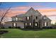 Charming two-story home with brick and stone facade, landscaped yard, and covered front entry at 4429 Serengeti Cir, Carmel, IN 46074