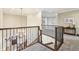 A brightly lit second-floor hallway features views of the home's foyer and stairs and decorative appointments at 4429 Serengeti Cir, Carmel, IN 46074