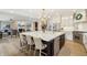 Modern kitchen featuring an oversized island with seating, stainless steel appliances, and hardwood floors at 4429 Serengeti Cir, Carmel, IN 46074