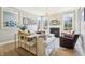 Cozy living room featuring a fireplace, hardwood floors, and ample natural light at 4429 Serengeti Cir, Carmel, IN 46074