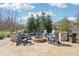 Cozy outdoor fire pit area with Adirondack chairs on a stone patio, perfect for gathering and enjoying the outdoors at 4429 Serengeti Cir, Carmel, IN 46074