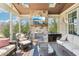 Inviting sunroom boasts a stone fireplace, TV, and comfortable seating for year-round relaxation and entertainment at 4429 Serengeti Cir, Carmel, IN 46074