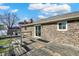Brick home with weathered wood back deck featuring glass sliding door at 4744 Whirlaway Dr, Indianapolis, IN 46237