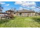 Backyard featuring a brick house, partially fenced yard and green space at 4744 Whirlaway Dr, Indianapolis, IN 46237