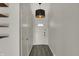 Bright hallway with vinyl flooring, light fixture, and access to various rooms in the house at 4744 Whirlaway Dr, Indianapolis, IN 46237