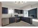 Stylish kitchen features dark cabinetry, granite countertops, and stainless steel appliances at 4744 Whirlaway Dr, Indianapolis, IN 46237