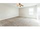 Neutral bedroom features a ceiling fan, carpet, and natural light at 4747 Summit Lake Pl, Indianapolis, IN 46239