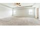 Spacious bedroom boasts a tray ceiling, neutral walls, carpet and natural light from the windows at 4747 Summit Lake Pl, Indianapolis, IN 46239