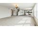 Spacious living area with modern ceiling fan open to the kitchen and staircase at 4747 Summit Lake Pl, Indianapolis, IN 46239