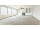 Cozy living room featuring a fireplace, built-in shelving, and large windows at 4747 Summit Lake Pl, Indianapolis, IN 46239