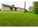 Expansive backyard features lush lawn, perimeter fence, and neutral-toned home exterior at 5446 Lippan Way, Indianapolis, IN 46221