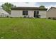 Exterior backyard featuring a chair, grill, lush lawn, and white siding at 5446 Lippan Way, Indianapolis, IN 46221