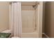Neutral bathroom featuring a shower-tub combo, showerhead, and a colorful shower curtain at 5446 Lippan Way, Indianapolis, IN 46221