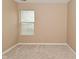 Bright bedroom featuring neutral walls, carpeting, and a large window with blinds at 5446 Lippan Way, Indianapolis, IN 46221