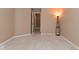 Carpeted neutral bedroom featuring a lamp, closet, and open door at 5446 Lippan Way, Indianapolis, IN 46221