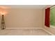 Neutral bedroom featuring carpet floors, lamp, window, and red curtains at 5446 Lippan Way, Indianapolis, IN 46221