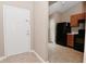 View of the entryway with coat closet leading into the kitchen with black appliances at 5446 Lippan Way, Indianapolis, IN 46221