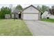Charming one story home featuring a two car garage and a brick and vinyl facade at 5446 Lippan Way, Indianapolis, IN 46221