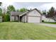 Charming one story home featuring a two car garage and a brick and vinyl facade at 5446 Lippan Way, Indianapolis, IN 46221