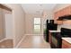 Eat-in kitchen features neutral paint, tile flooring, light wood cabinets, and black appliances at 5446 Lippan Way, Indianapolis, IN 46221