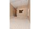 Open-concept living room featuring neutral walls, carpeting, chandelier, and natural light from adjacent room at 5446 Lippan Way, Indianapolis, IN 46221