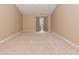 Spacious carpeted living room with neutral paint, a ceiling fan, and a sliding glass door at 5446 Lippan Way, Indianapolis, IN 46221