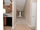 Open concept living room with neutral paint, tile entry, and carpeted living area at 5446 Lippan Way, Indianapolis, IN 46221