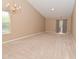 Spacious carpeted living room featuring a chandelier and a sliding glass door to the outside at 5446 Lippan Way, Indianapolis, IN 46221