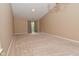 Spacious living room with neutral carpeting, complemented by sliding glass doors and a modern ceiling light at 5446 Lippan Way, Indianapolis, IN 46221