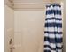 Standard shower with blue and white striped curtain, simple and functional for everyday use at 5446 Lippan Way, Indianapolis, IN 46221