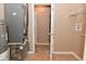 Mechanical room with tile flooring, water heater, and door leading to carpeted interior room at 5446 Lippan Way, Indianapolis, IN 46221