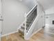 Inviting staircase with carpeted steps and modern railing, complemented by wood floors at 6059 S Bay Dr, Indianapolis, IN 46250