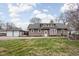 Spacious backyard with a deck, detached garage, and well-kept lawn at 6158 Ralston Ave, Indianapolis, IN 46220